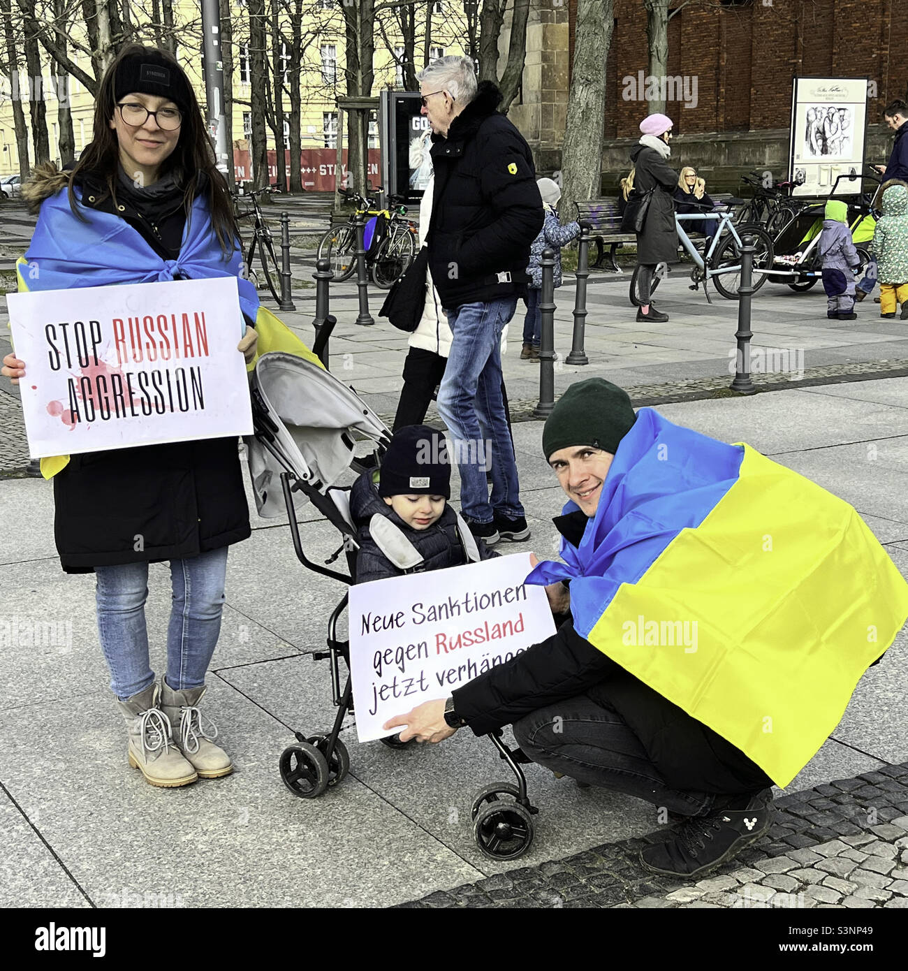 Germany,Mitte. 27  February 2022. Family join peace protest in support of Ukraine during Russian military offense - Smartphone Captured Stock Image