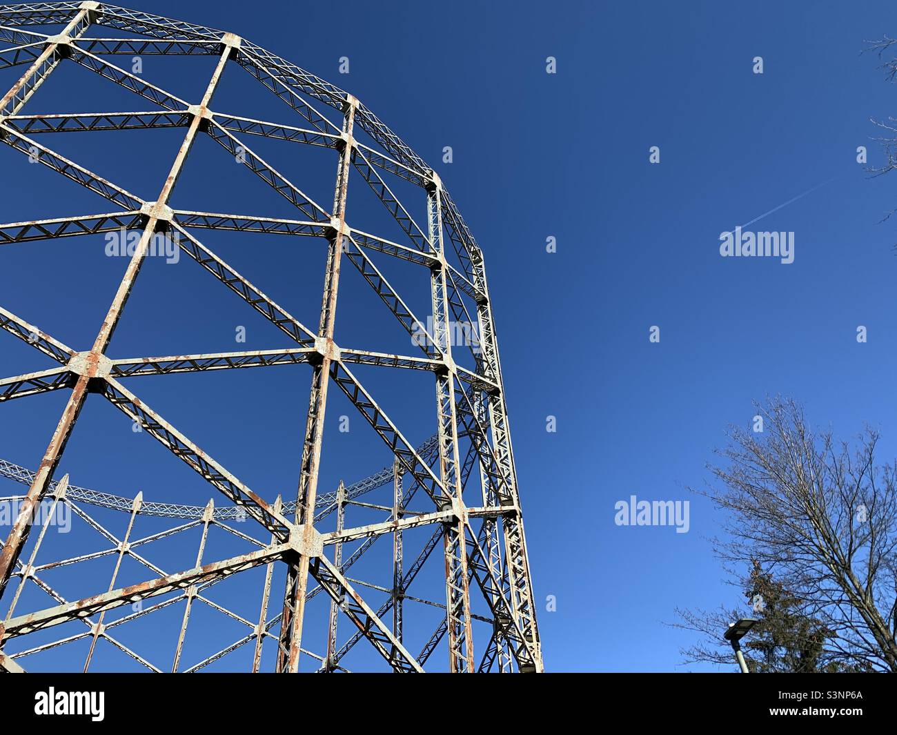 Disused Gasometer against deep blue sky Stock Photo