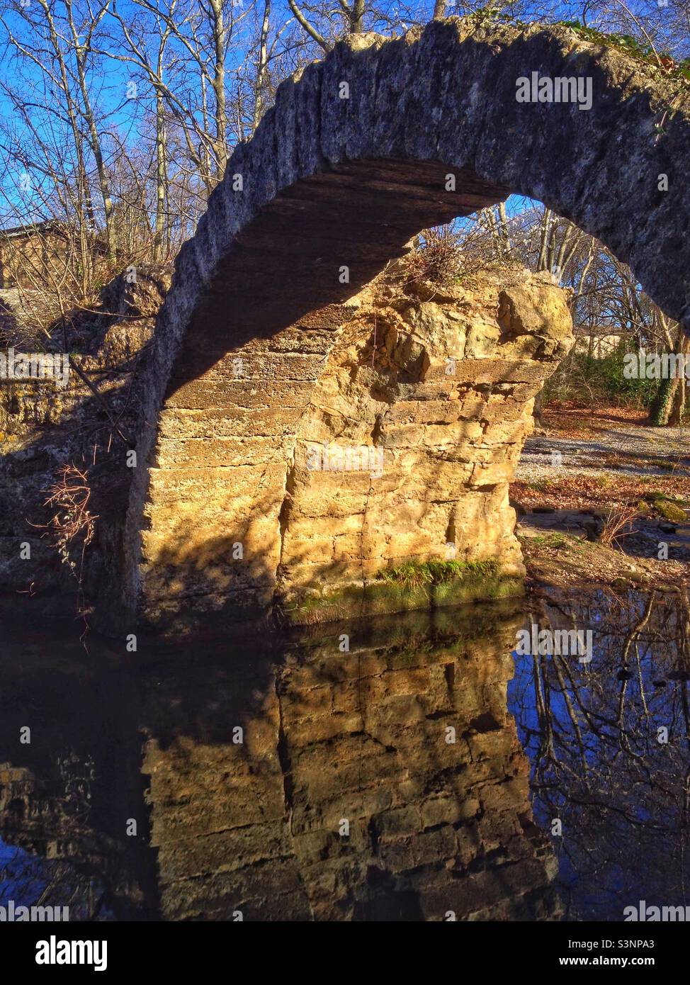 Old Roman bridge overdose La Mosson river in Montpellier. Occitanie, France - Smartphone Captured Stock Image