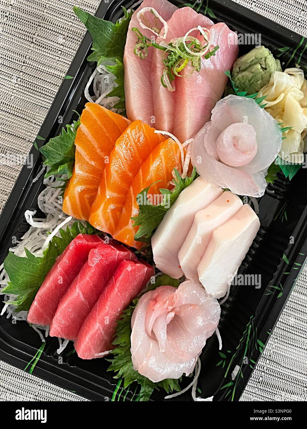Close up of a takeout delivery box of fresh sashimi - Smartphone Captured Stock Image
