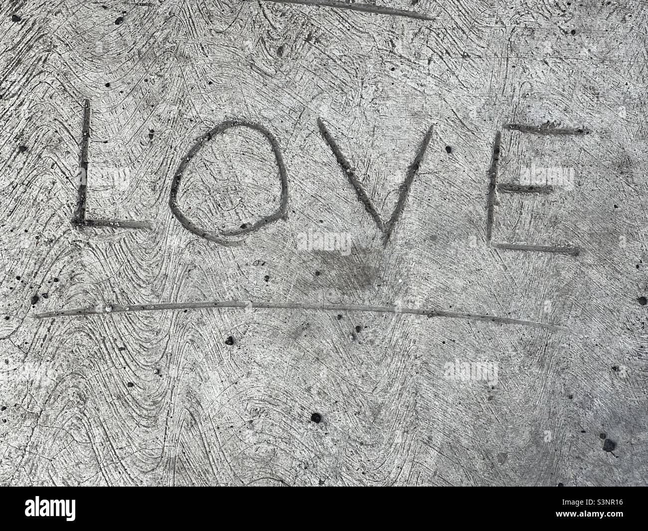 Love word carved over a concrete step Stock Photo