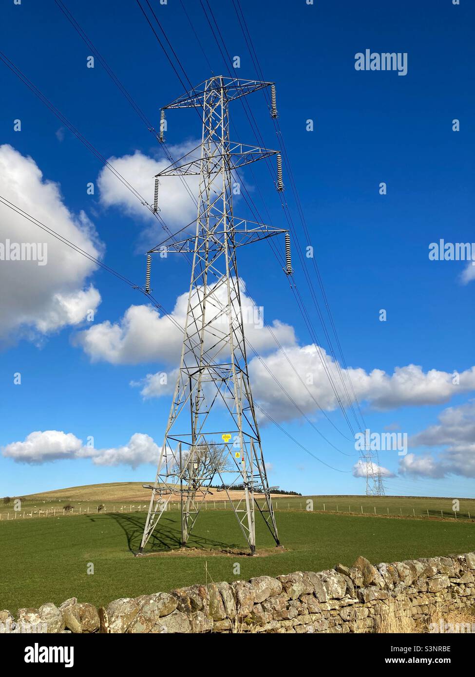 Electricity Pylon situated in the countryside on a sunny day - Smartphone Captured Stock Image