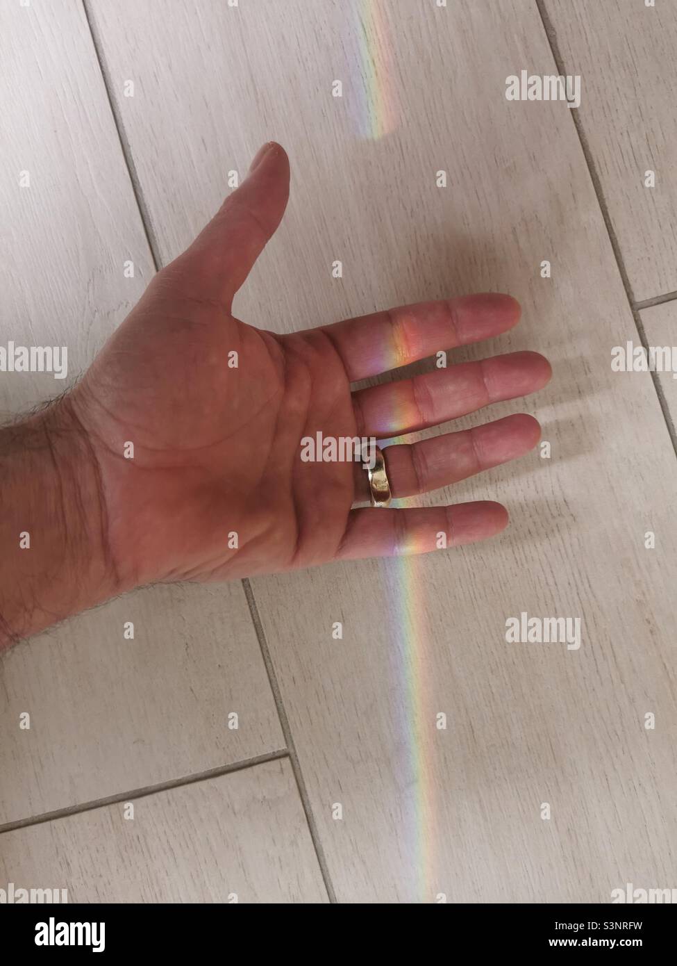 male hand holding a rainbow Stock Photo