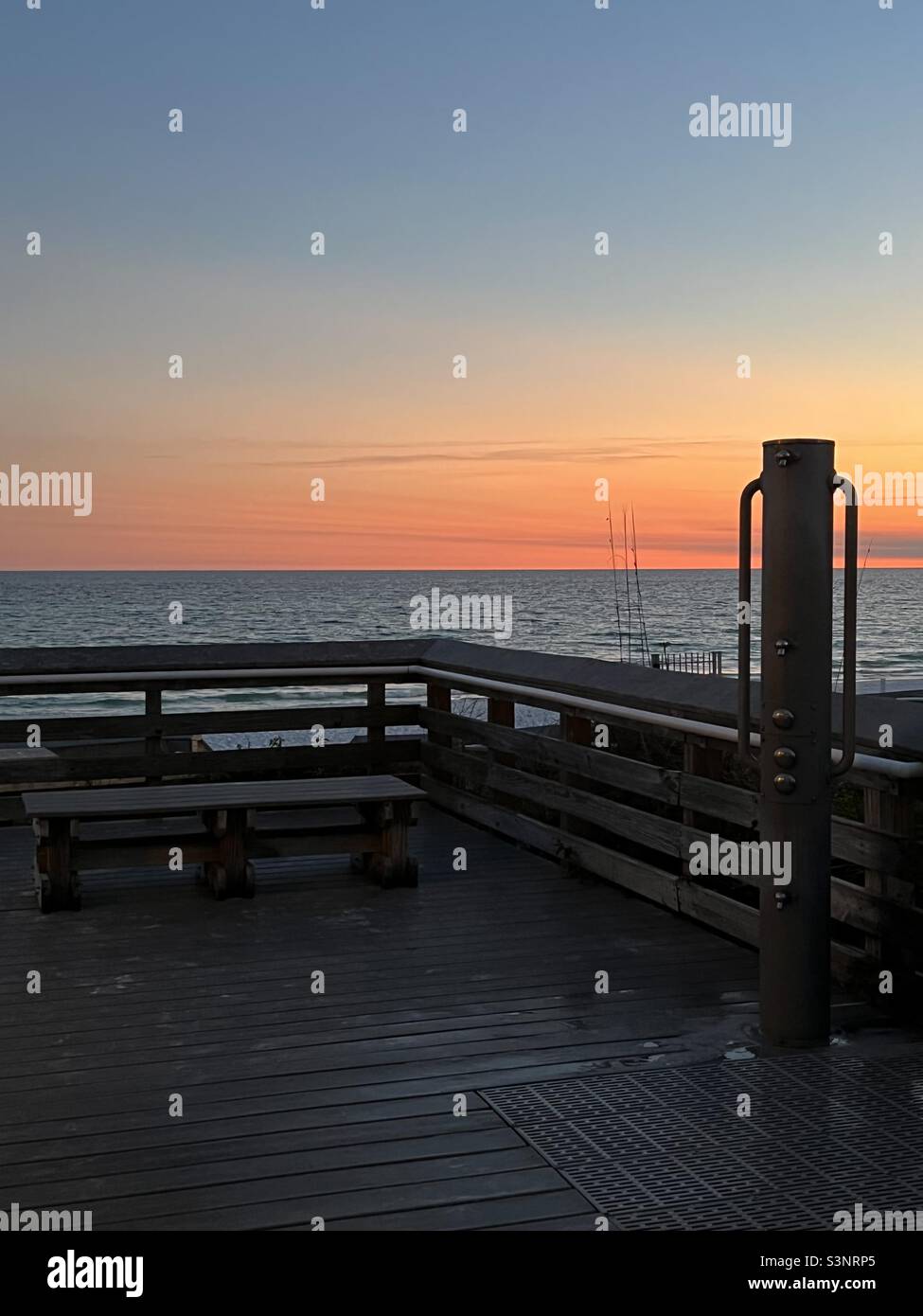 Colorful sunset over the Gulf of Mexico Florida with outdoor shower and bench area - Smartphone Captured Stock Image
