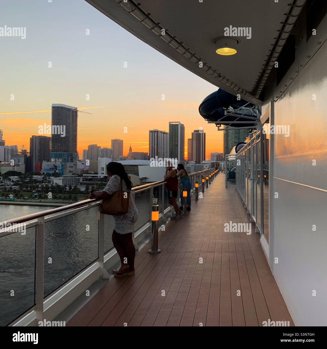 January, 2022, people watching the sunset from the deck as the MSC Divina leaves the Port of Miami, Miami, Florida, United States, North America - Smartphone Captured Stock Image