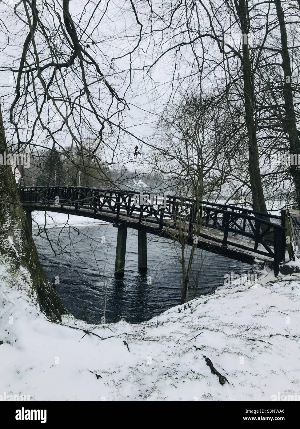 Bridge over the snowed and frozen lake Stock Photo