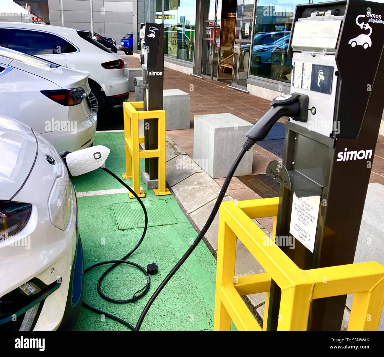 Electric car charging points in use in Spain - Smartphone Captured Stock Image