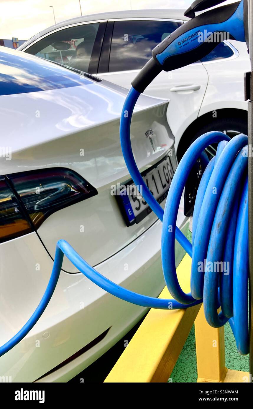 Tesla electric car charging at a charging point in Spain - Smartphone Captured Stock Image