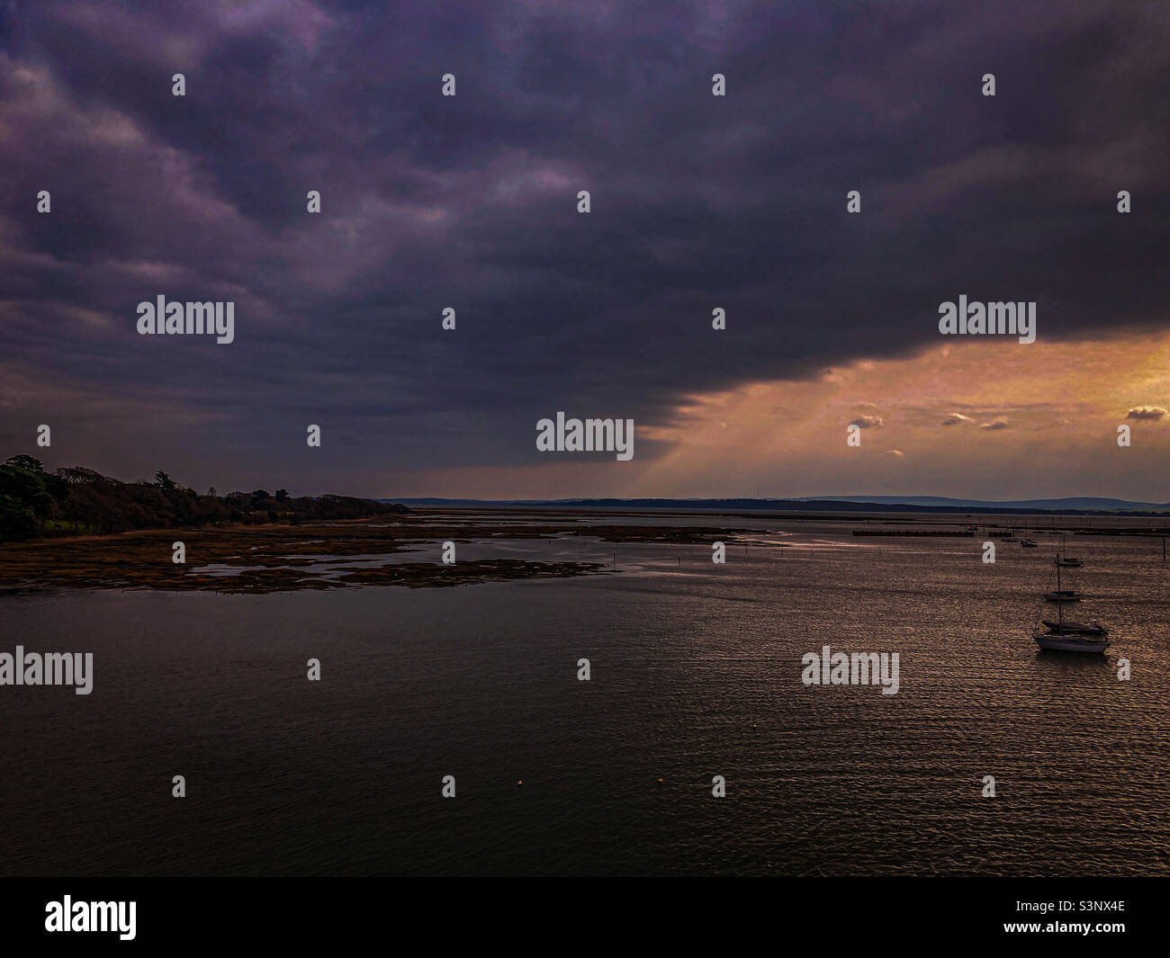 Vivid coastal scene with clouds and sun - Smartphone Captured Stock Image