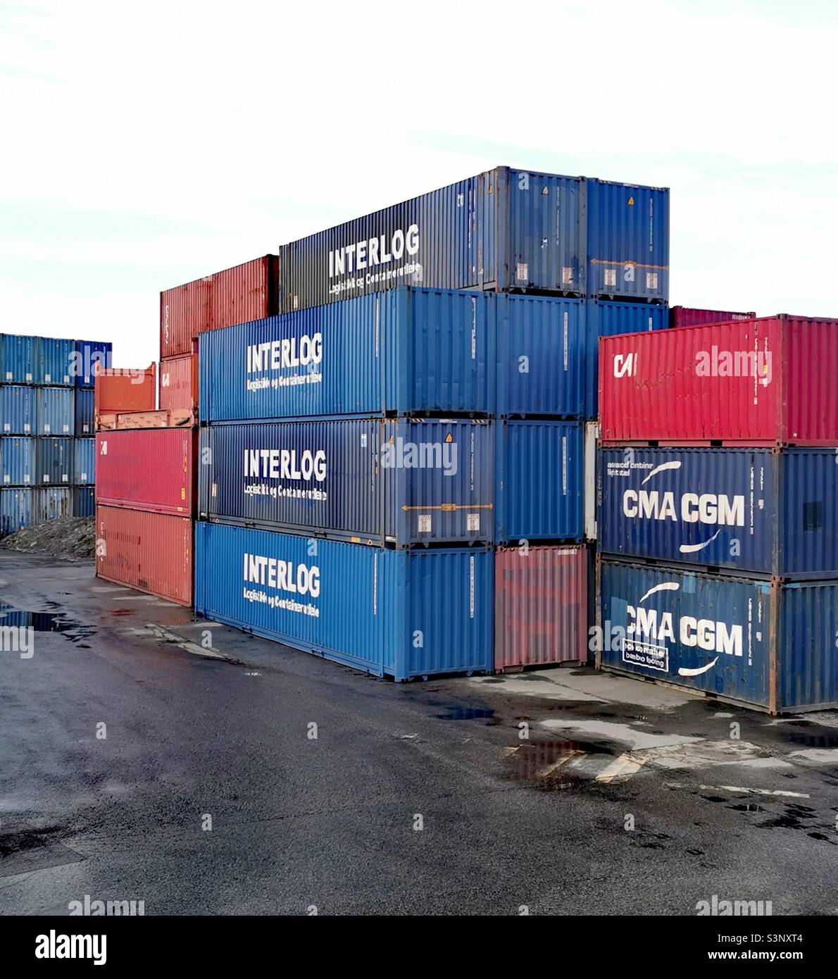 shipping containers stacked up in depot Stock Photo