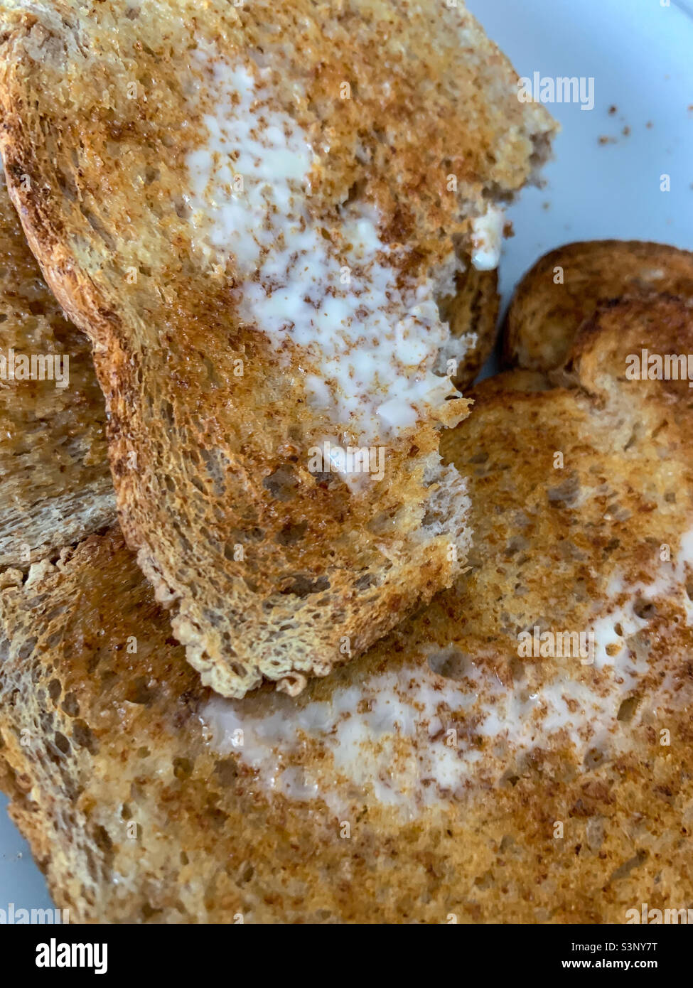 Slice of Wholemeal toast and butter with bite taken out - Smartphone Captured Stock Image