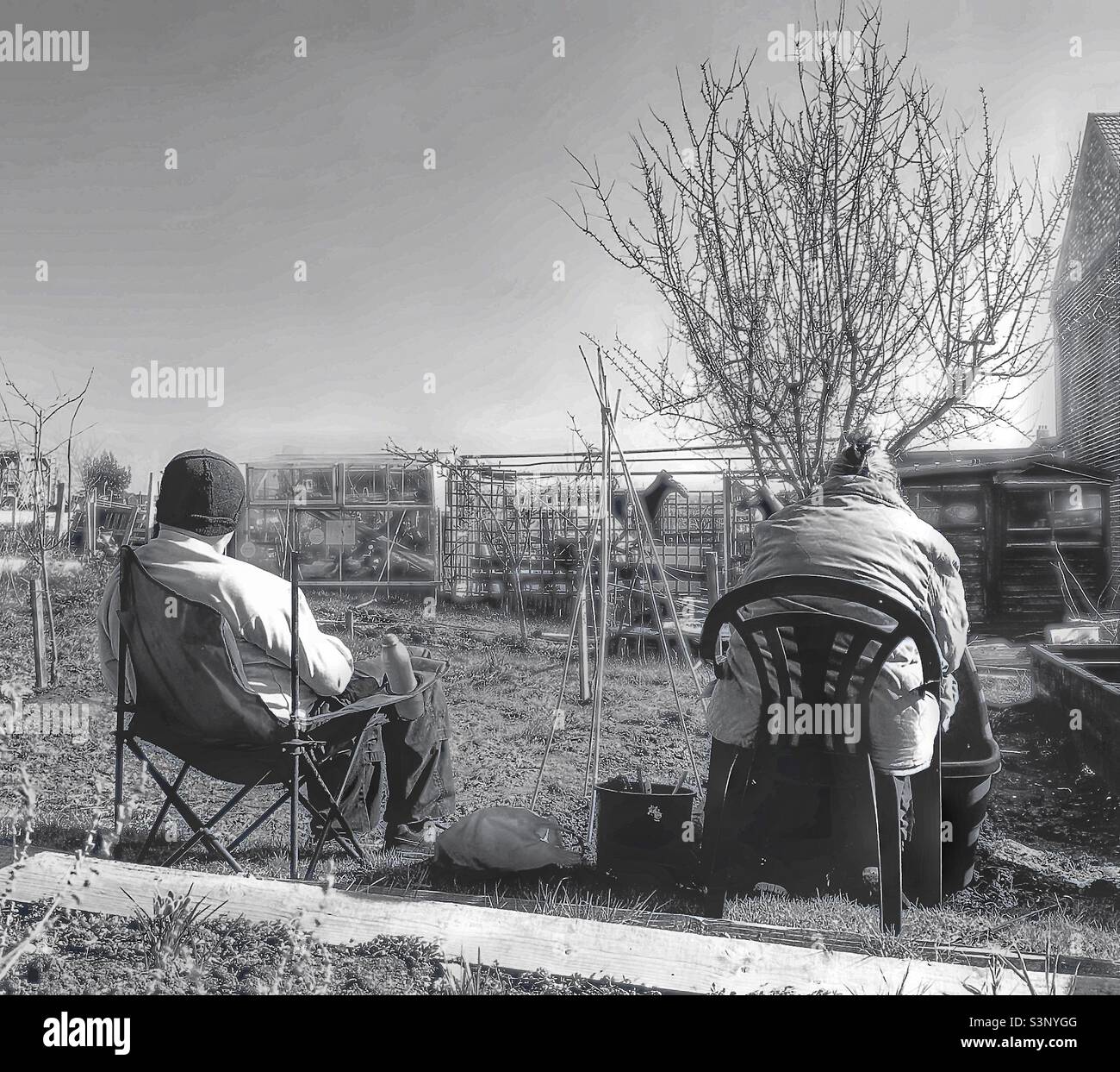 A mature couple sitting outside. Stock Photo