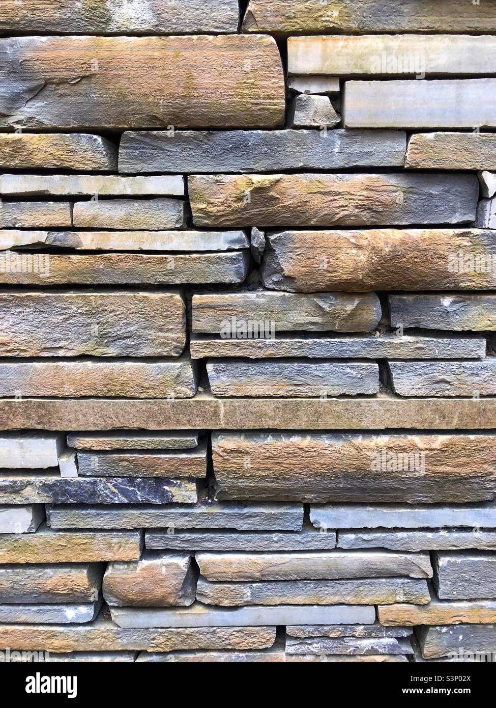Stacked slate wall layers of a building - Smartphone Captured Stock Image