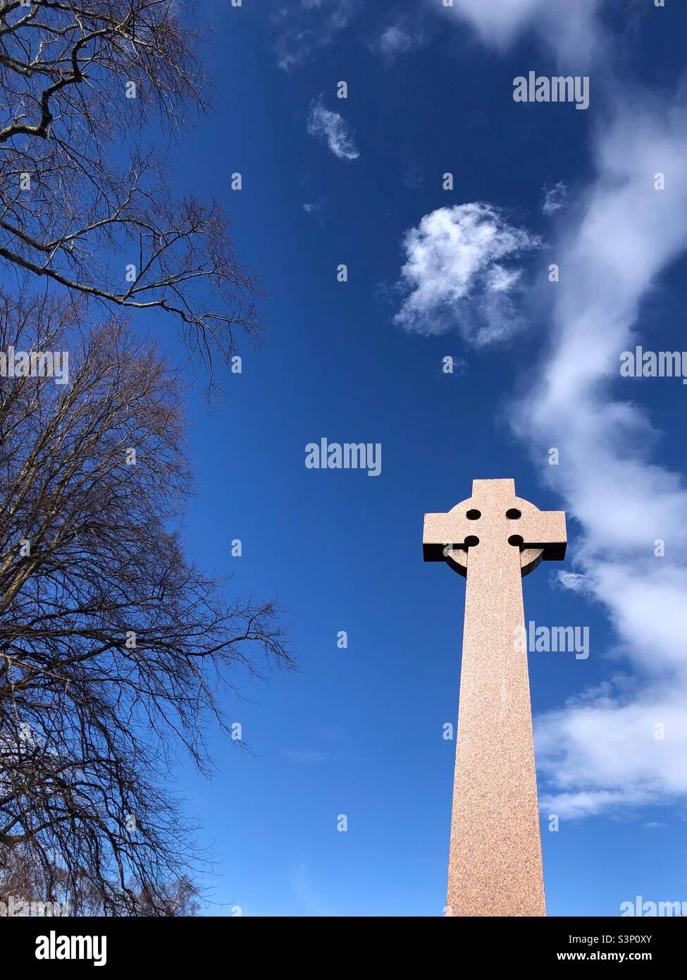 Gravestone against a blue sky - Smartphone Captured Stock Image