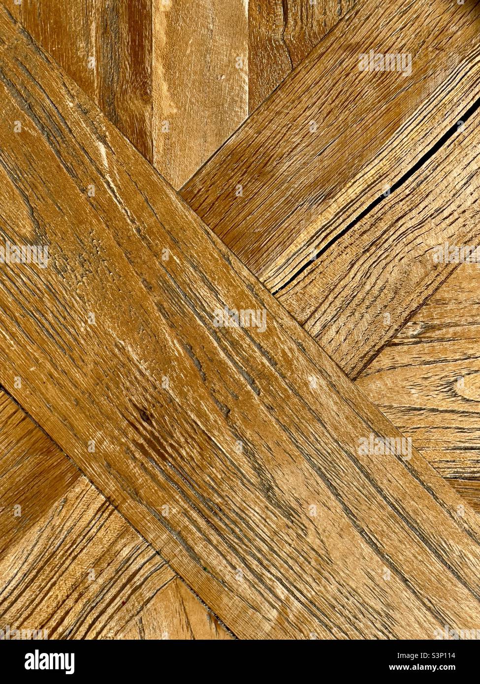 The criss-cross pattern of grain in a wooden pub table top - Smartphone Captured Stock Image