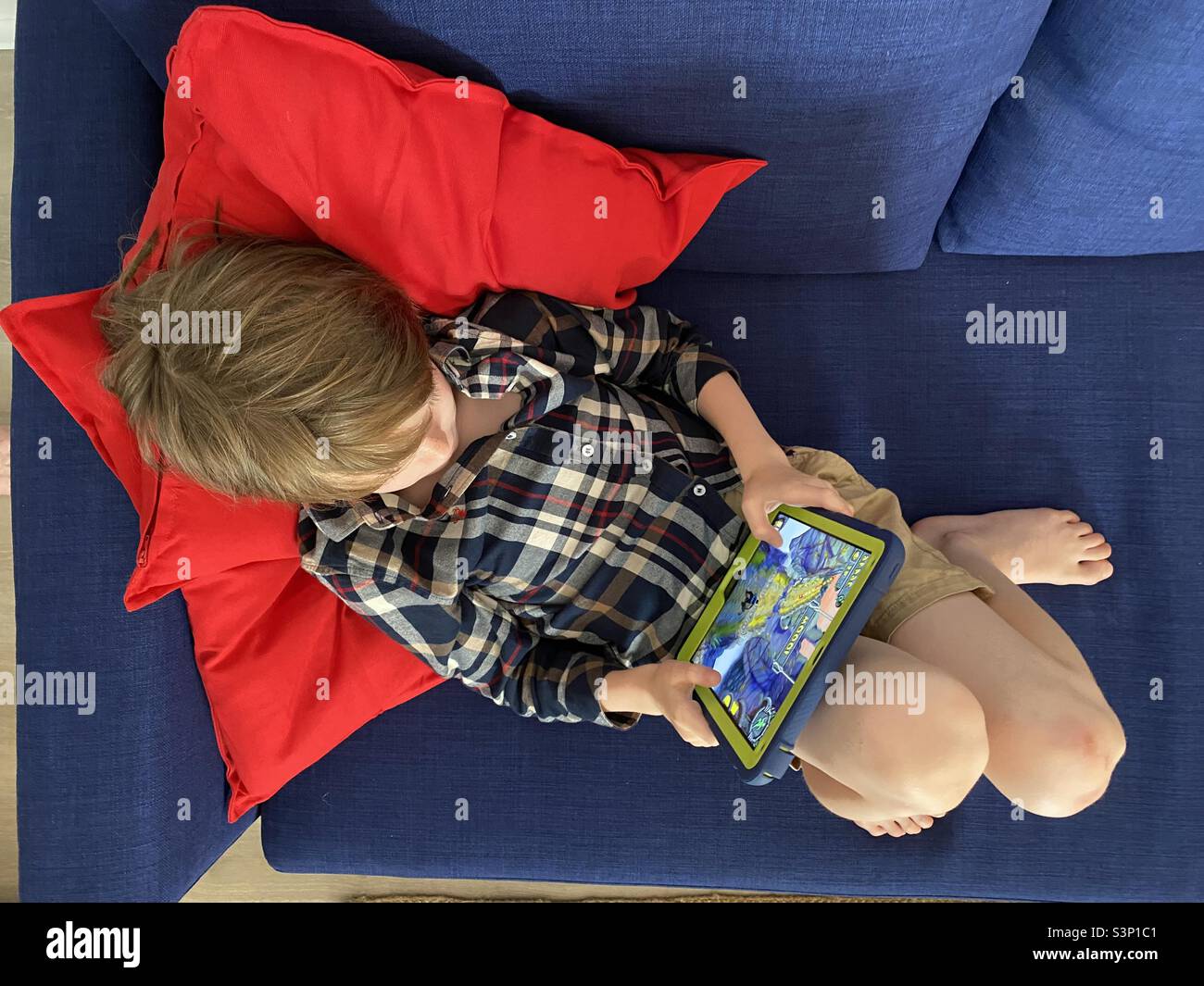 Top view of child playing video games on an iPad Stock Photo
