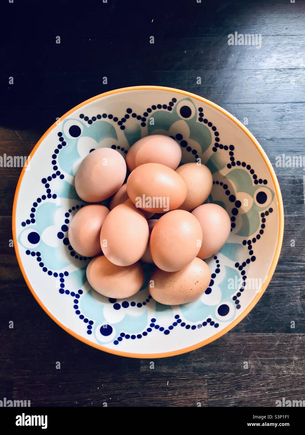 Arial view of a dozen eggs in a decorative bowl Stock Photo