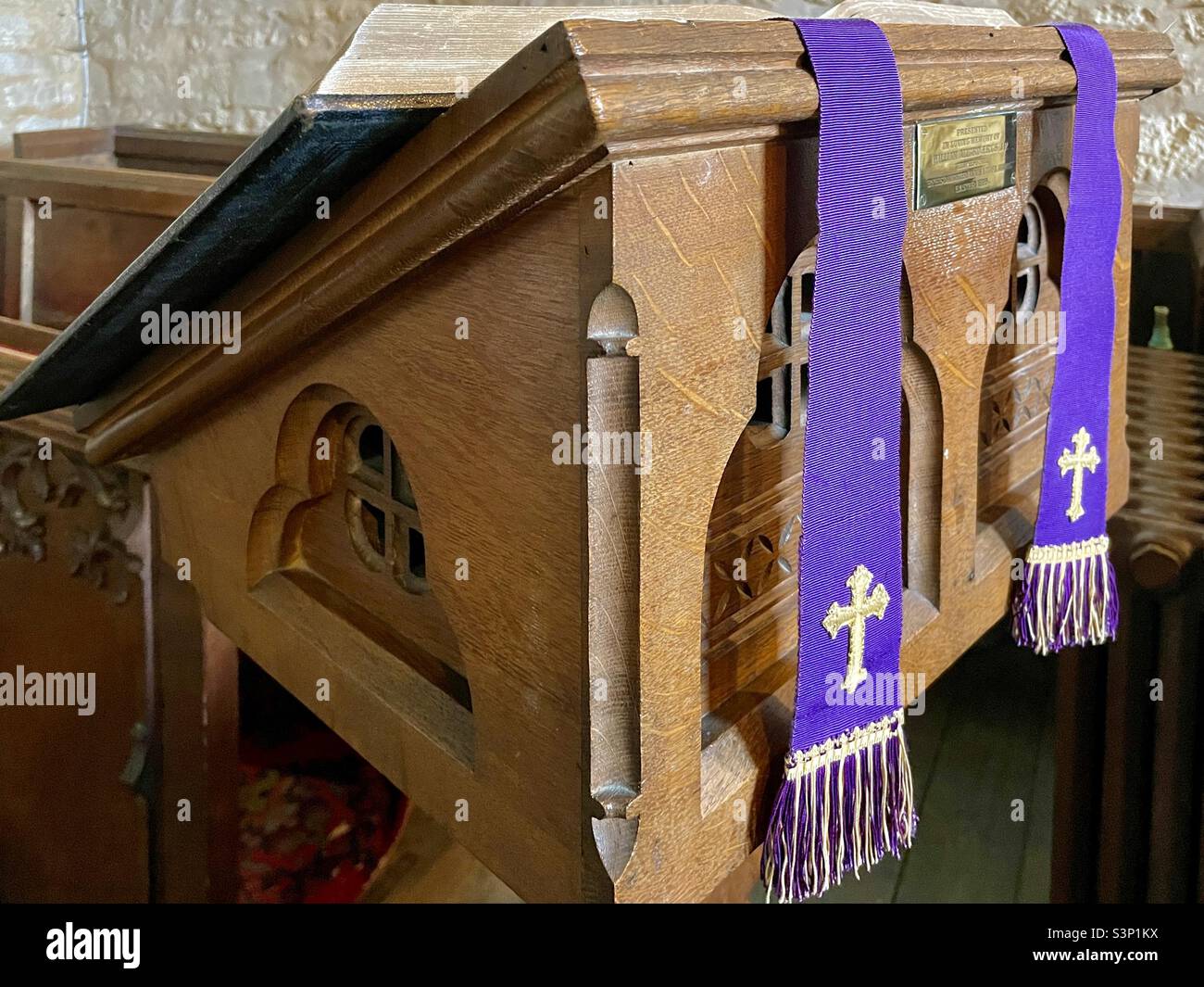 A carved oak lectern bearing a Holy Bible In Beckford Parish Church in the county of Worcestershire, UK - Smartphone Captured Stock Image