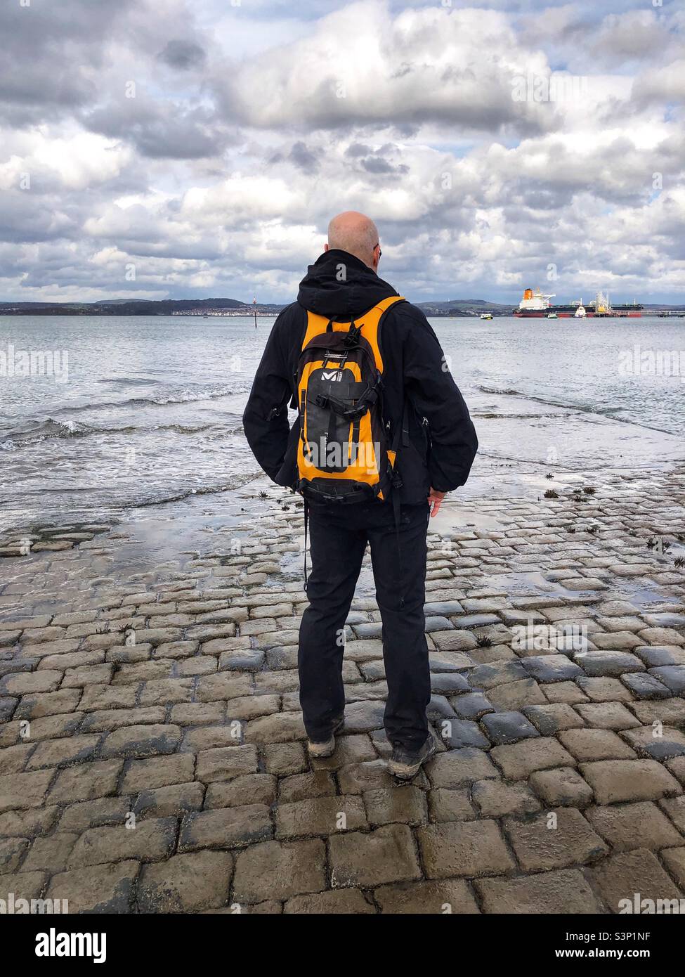 Man look out onto the Forth Estuary, South Queensferry, Scotland - Smartphone Captured Stock Image