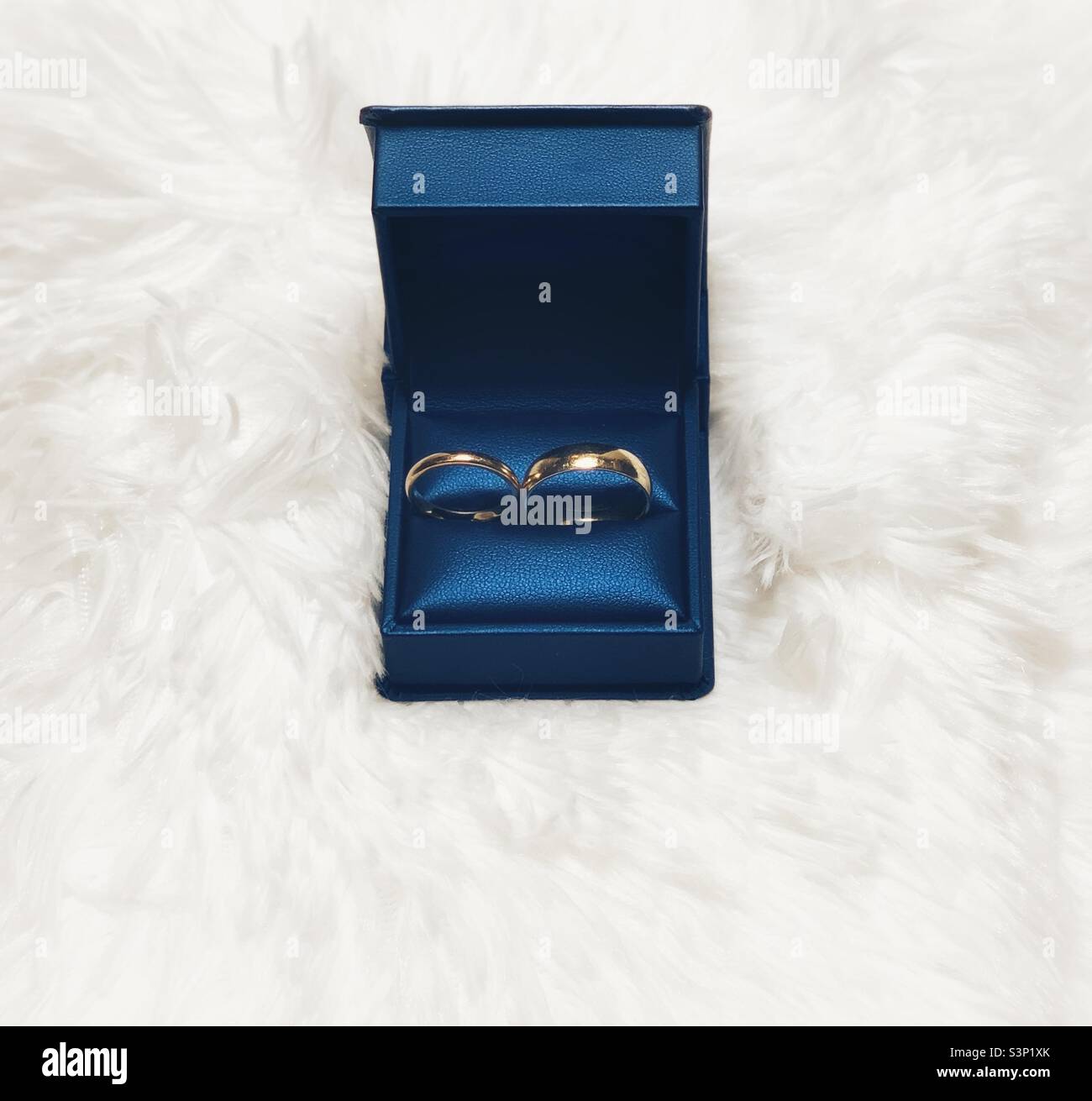 Wedding bands in blue jewelry box - Smartphone Captured Stock Image