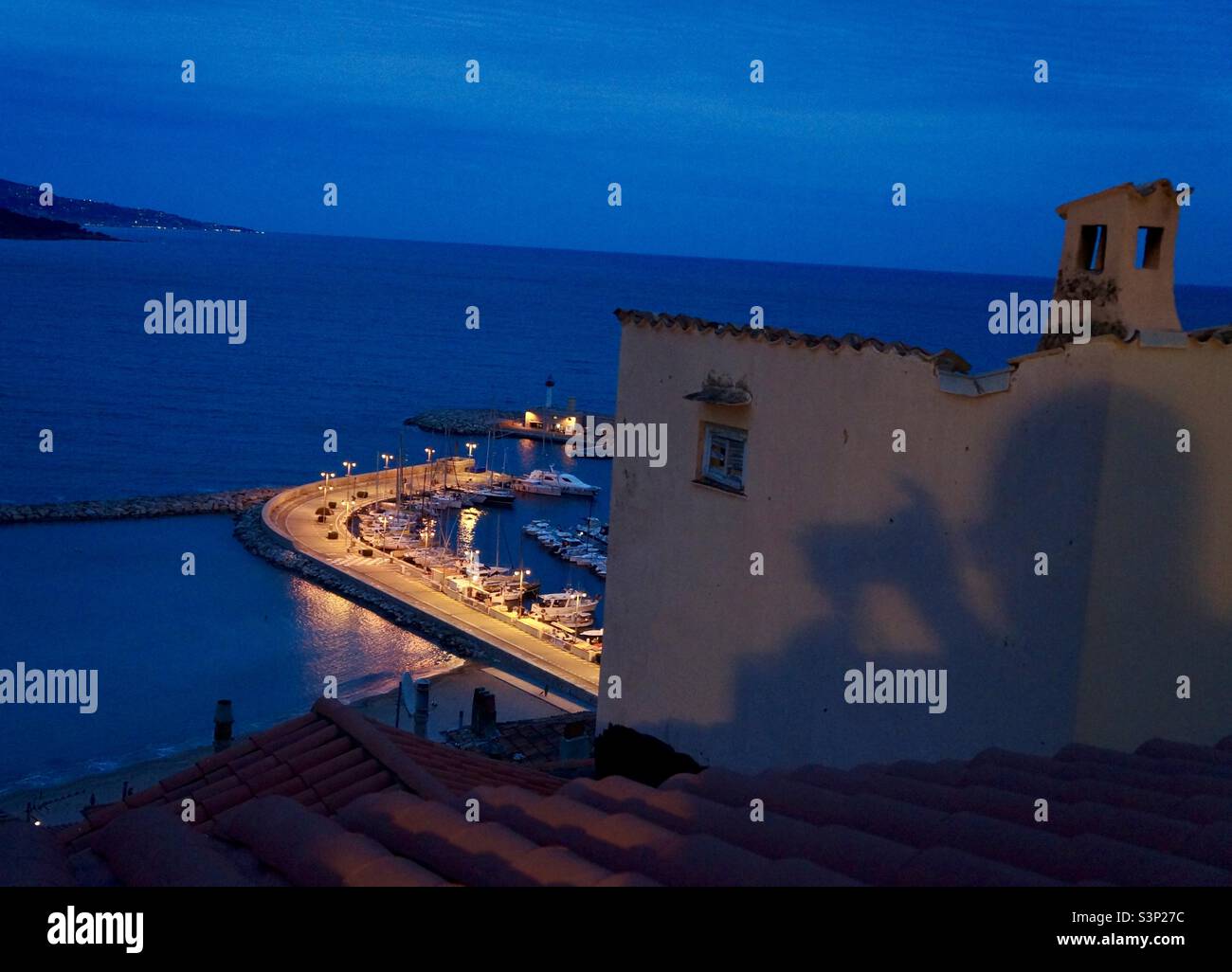 'The eye is always caught by light, but shadows have more to say.' -Gregory Maguire The old port of Menton. - Smartphone Captured Stock Image