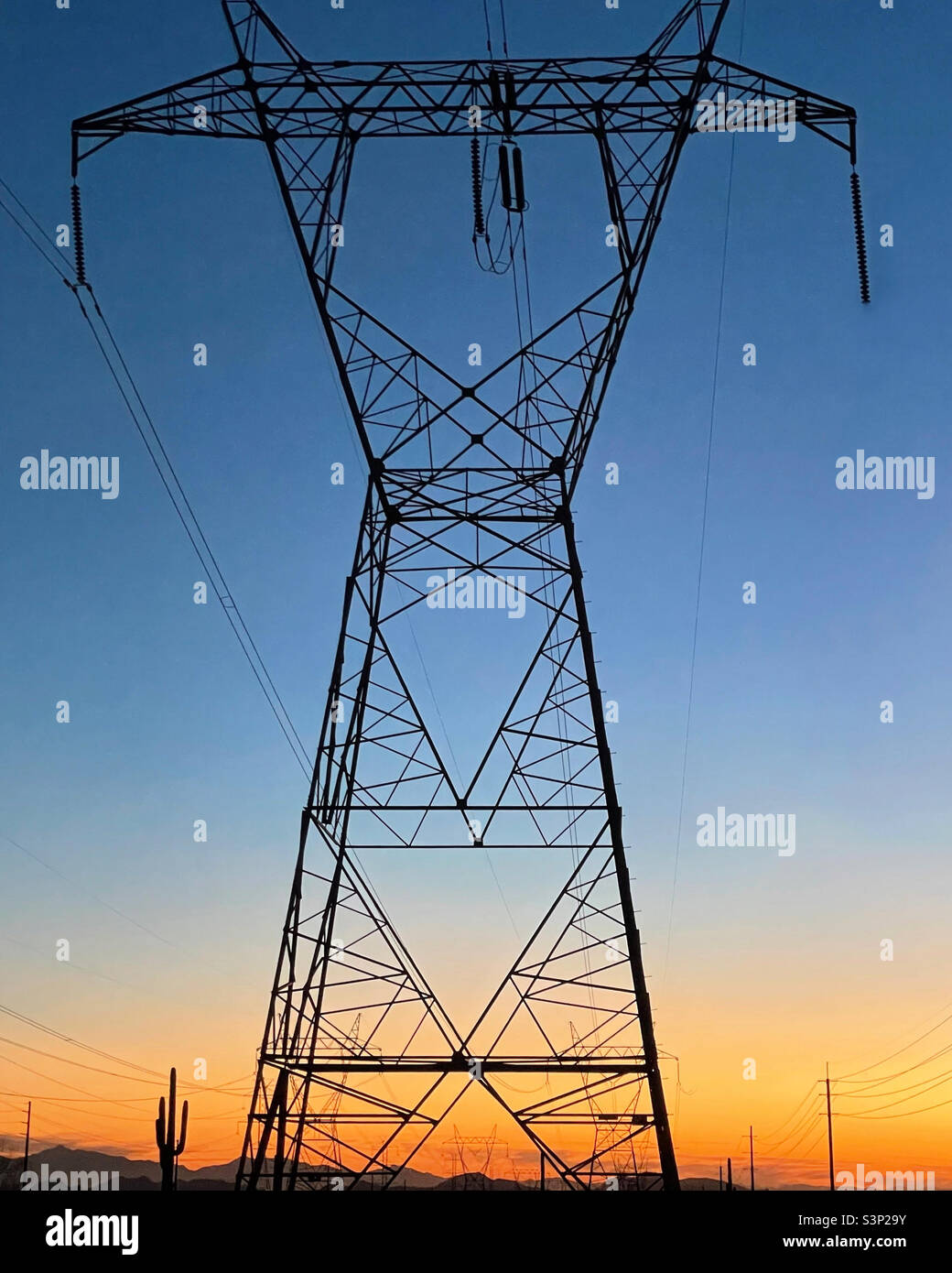 High voltage power transmission tower at sunset - Smartphone Captured Stock Image