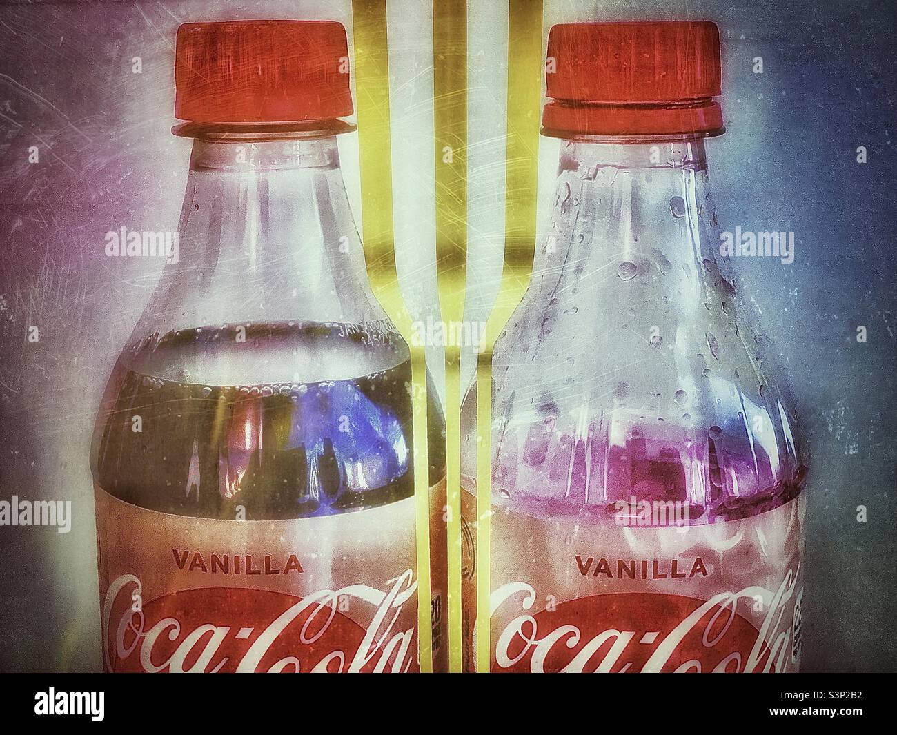 Two bottles of Vanilla Coke, one full and the other empty. Grunge effect and golden lined design digitally added via IOS apps. - Smartphone Captured Stock Image