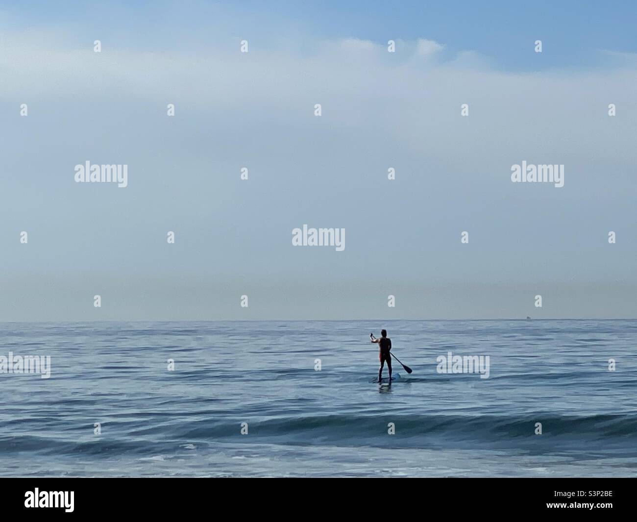 Paddle board rider on gentle water - Smartphone Captured Stock Image