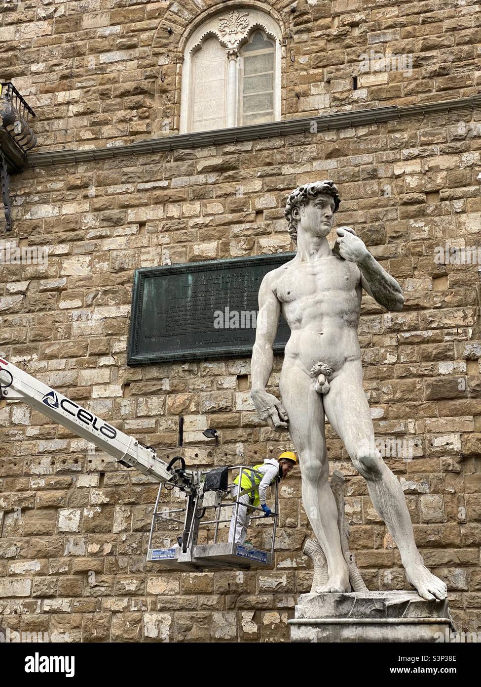 16.03 2022 Florence Italy Worker in a crane cleaning the sculpture of David outside piazza della  signoria in Florence Italy Stock Photo