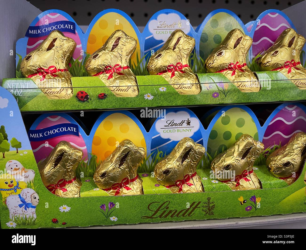 Easter bunnies wrapped in gold foil in a display at a retail outlet, 2022, USA Stock Photo