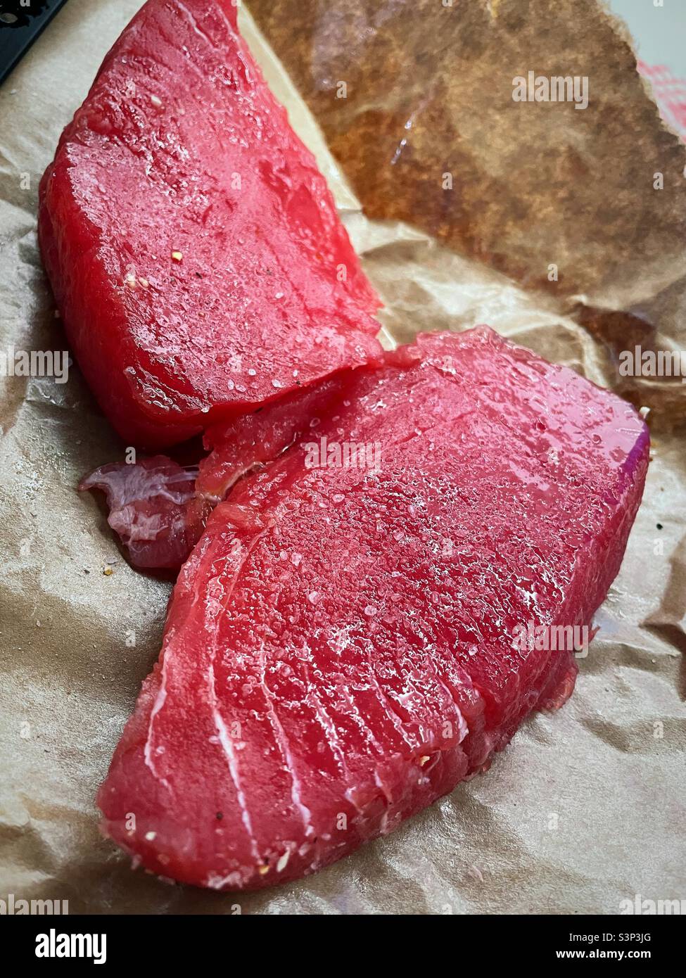 Fresh sushi grade salmon steaks in the fishmonger’s  wrapping, 2022, United States - Smartphone Captured Stock Image