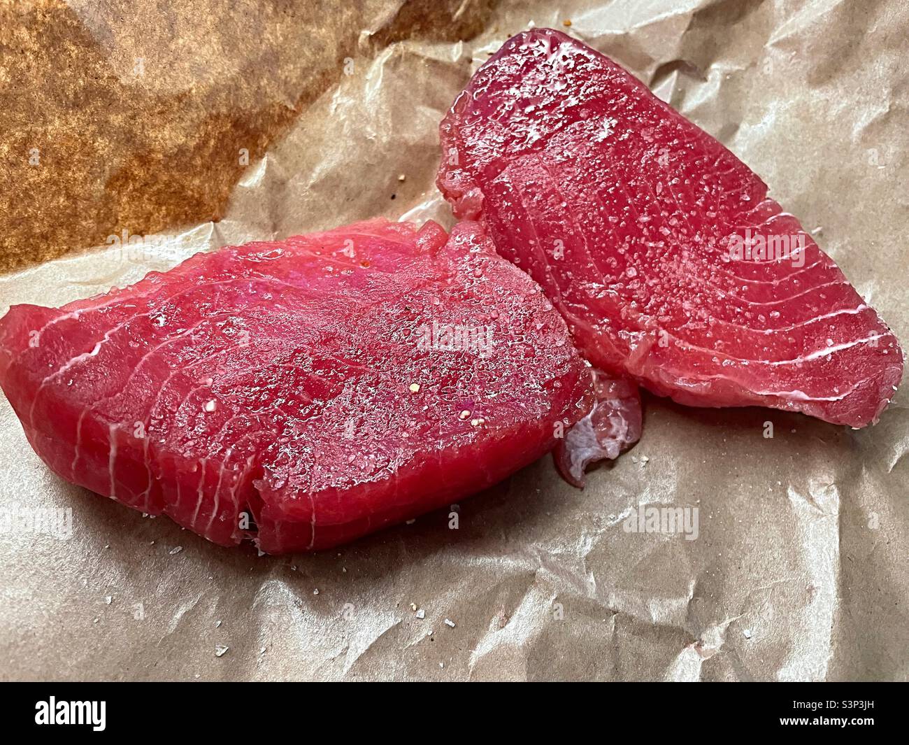 Close up of fresh tuna steaks at a fish market, 2022, USA - Smartphone Captured Stock Image