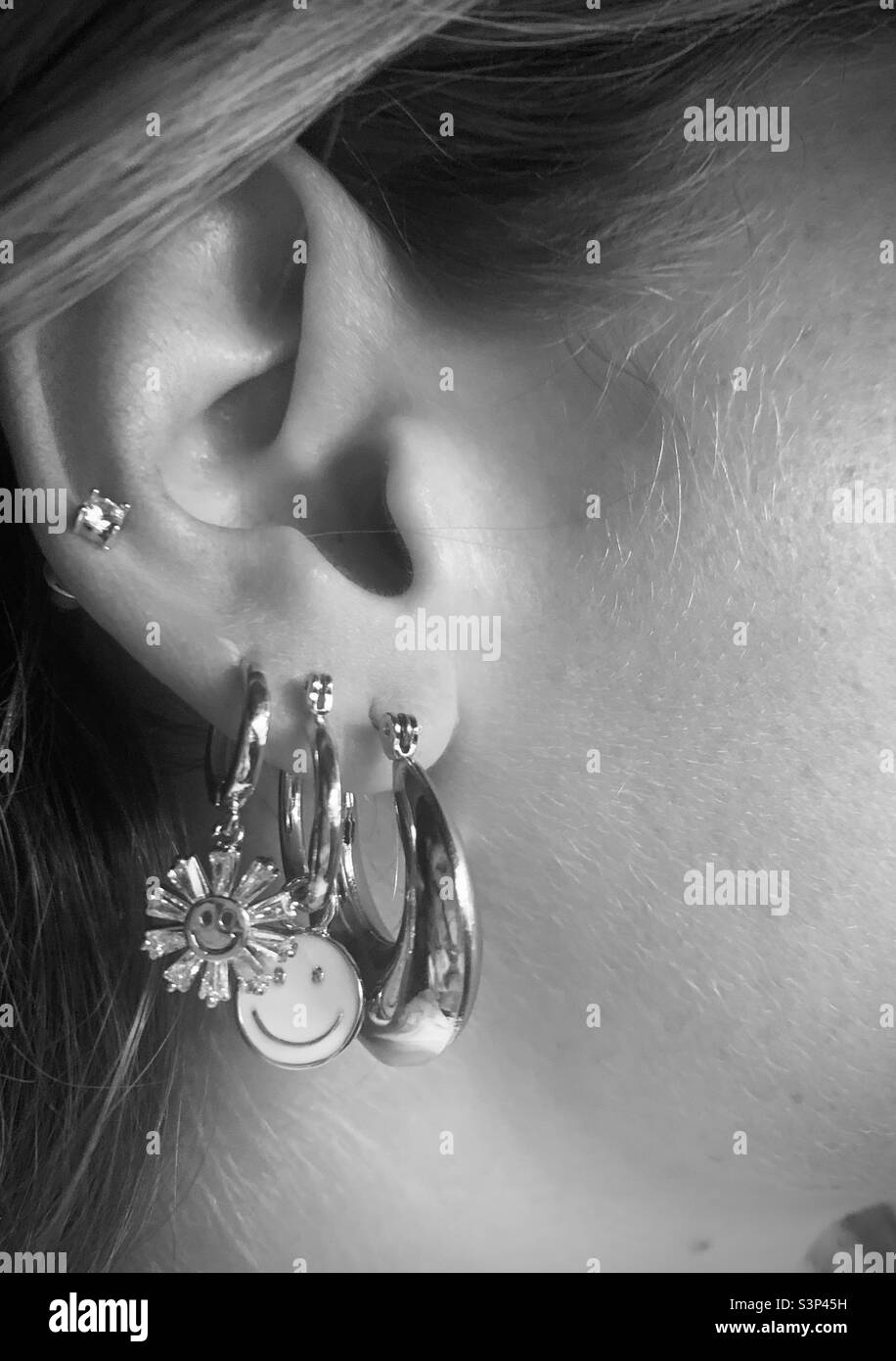 Girl wearing earrings - ears pierced Stock Photo