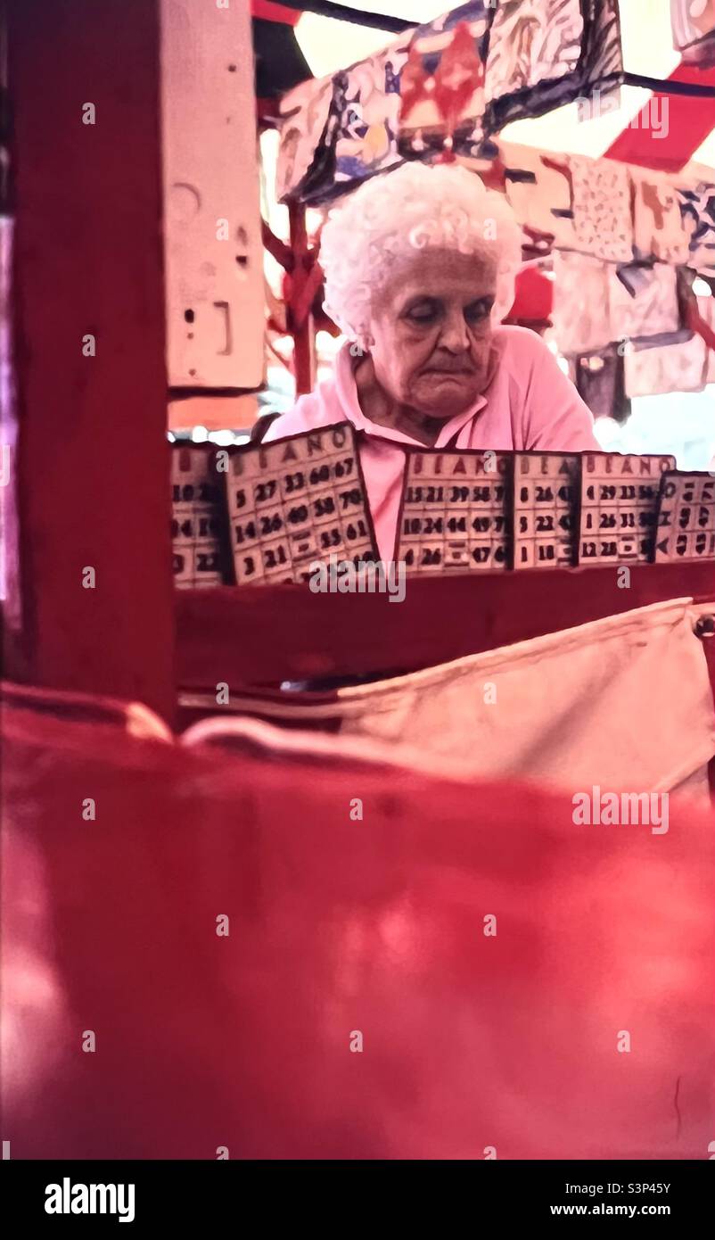 Senior citizen woman plays Bingo Beano game at  fair in New England Stock Photo