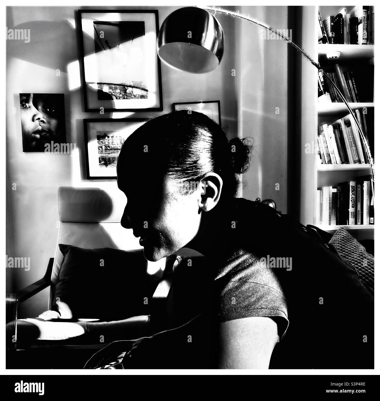 A  young woman relaxing at home. - Smartphone Captured Stock Image