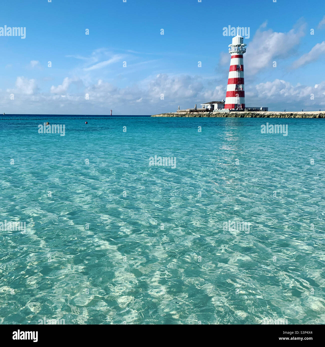 January, 2022, Lighthouse seen from the beach on Ocean Cay, the private island of MSC cruiseline, located in Bimini, Bahamas, seen during a cruise on the MSC Divina, from Miami, Florida - Smartphone Captured Stock Image
