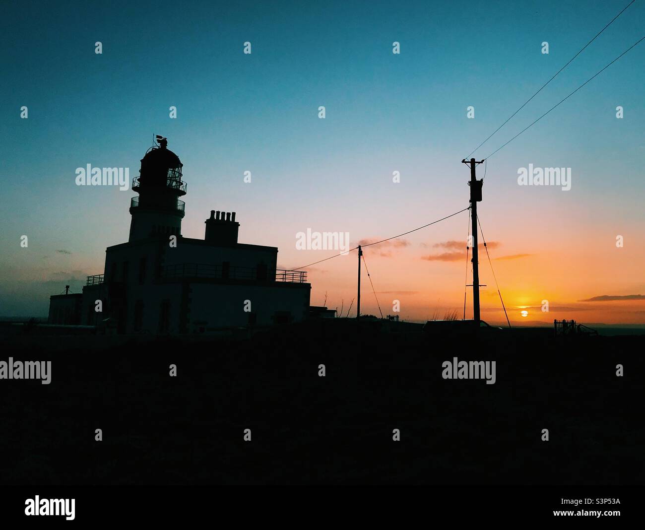 Lighthouse with sunset over the sea in Scotland - Smartphone Captured Stock Image