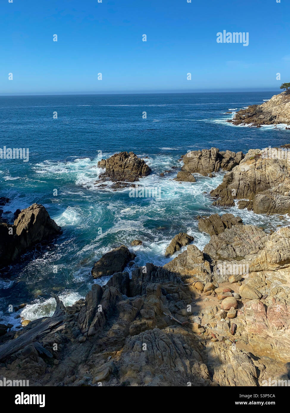 Rocky ocean and blue water. Stock Photo