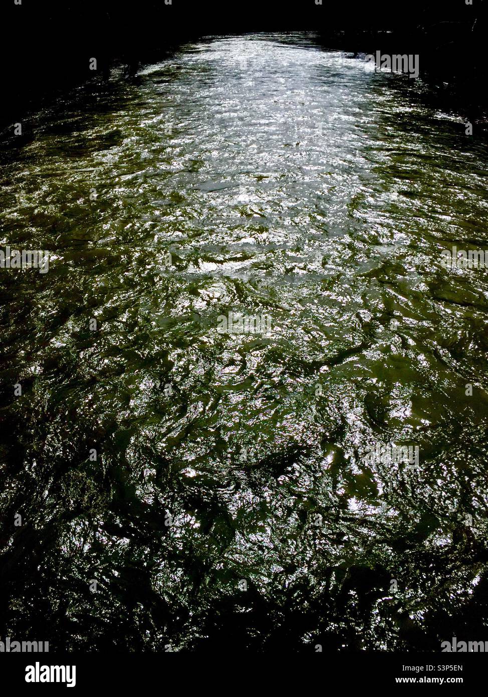 Spring thaw. Swollen river sparkles in sunshine. When the snow melts. Ontario. Canada. Improbable splendor. Alive with light. - Smartphone Captured Stock Image