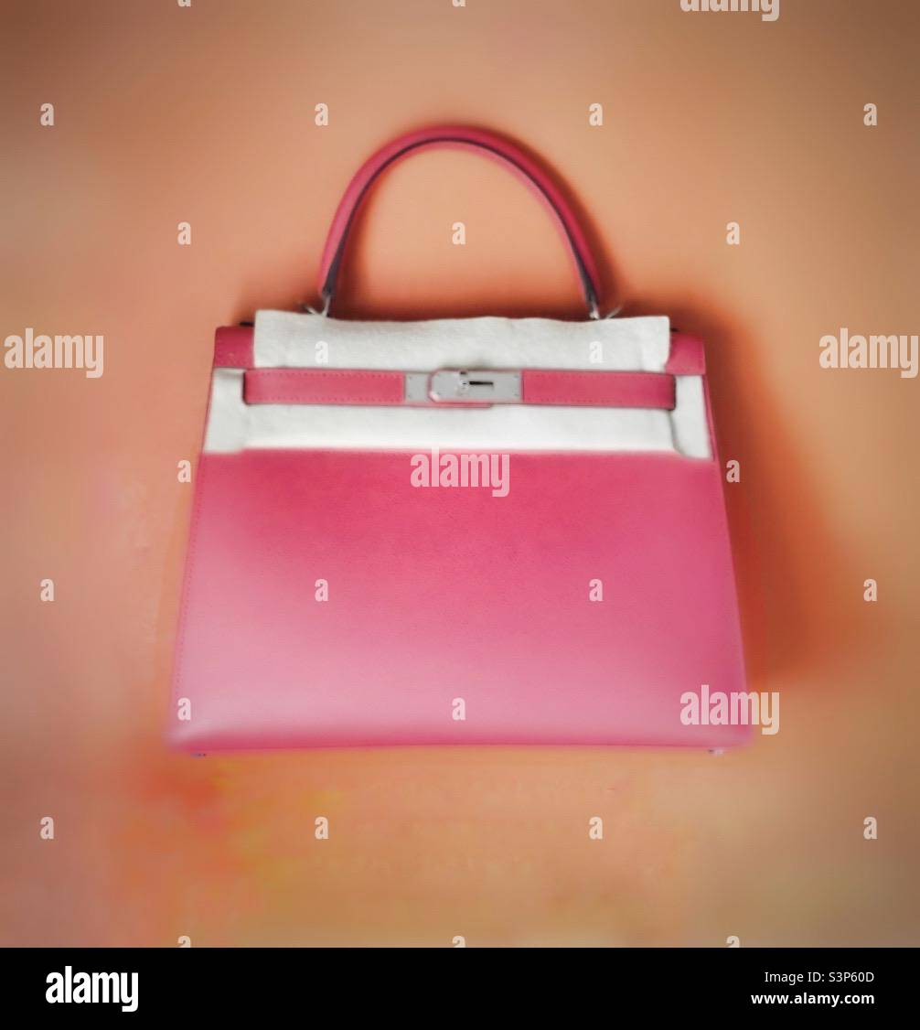 A small pink Kelly handbag. - Smartphone Captured Stock Image