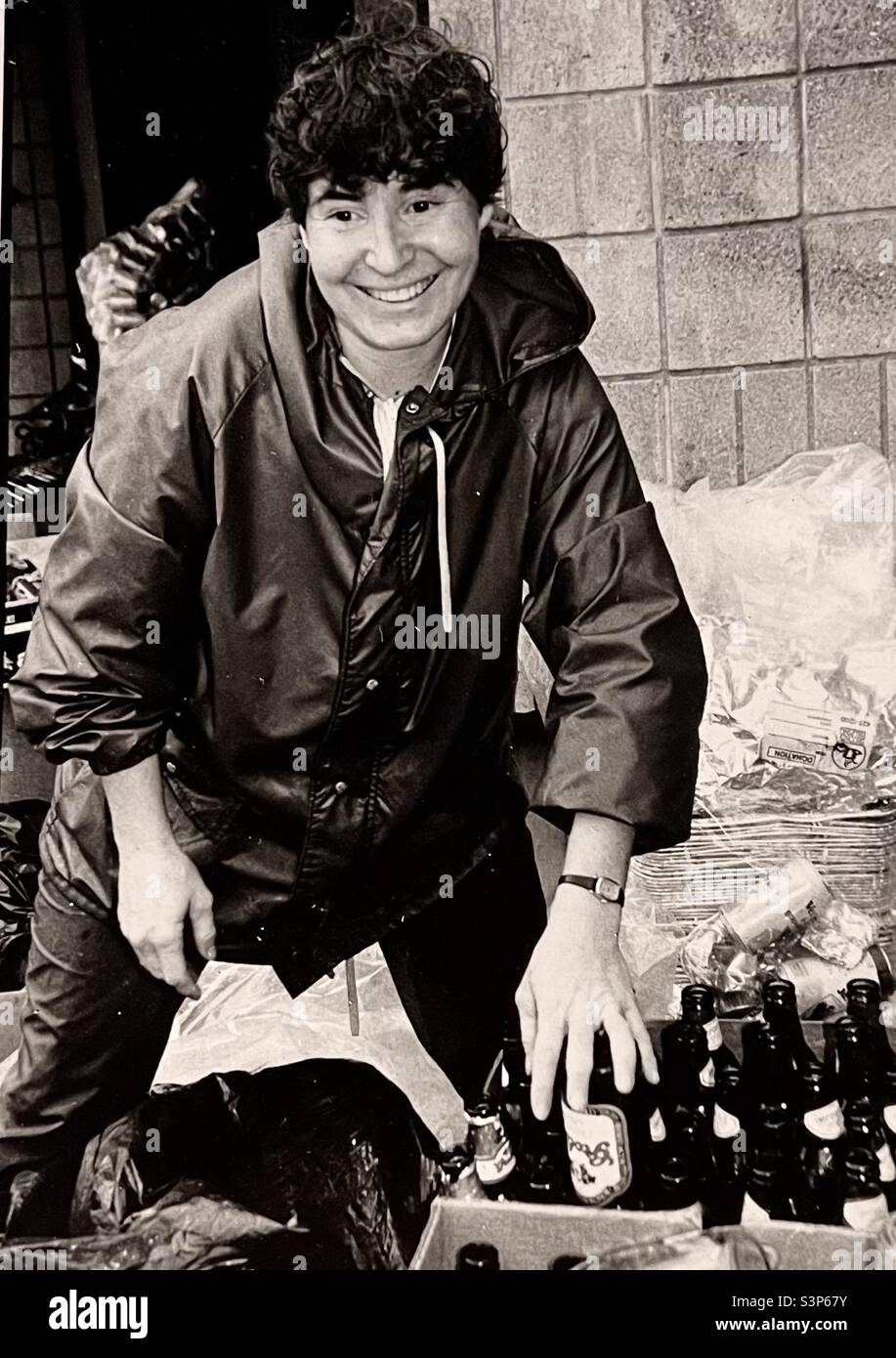 Woman volunteer sorting glass bottles at recycling center - Smartphone Captured Stock Image