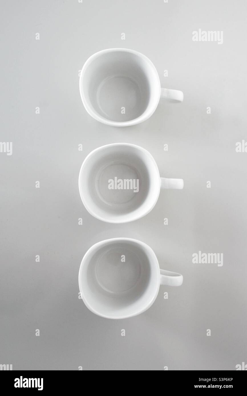 Row of white cups on the white background - Smartphone Captured Stock Image