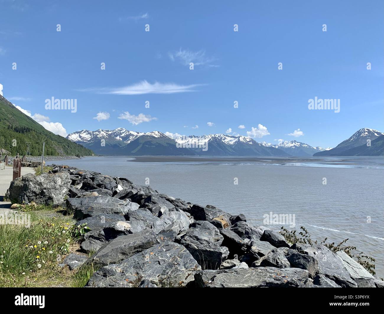 Rocky edge of the Seward Highway along Turnagain Arm with the inlet ...