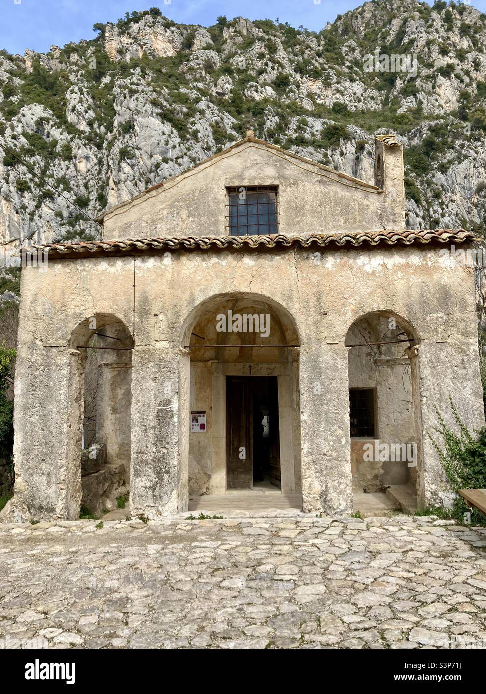 Chapelle Saint-Lazare with the French Alpes at its back just outside of Gorbio, France. - Smartphone Captured Stock Image