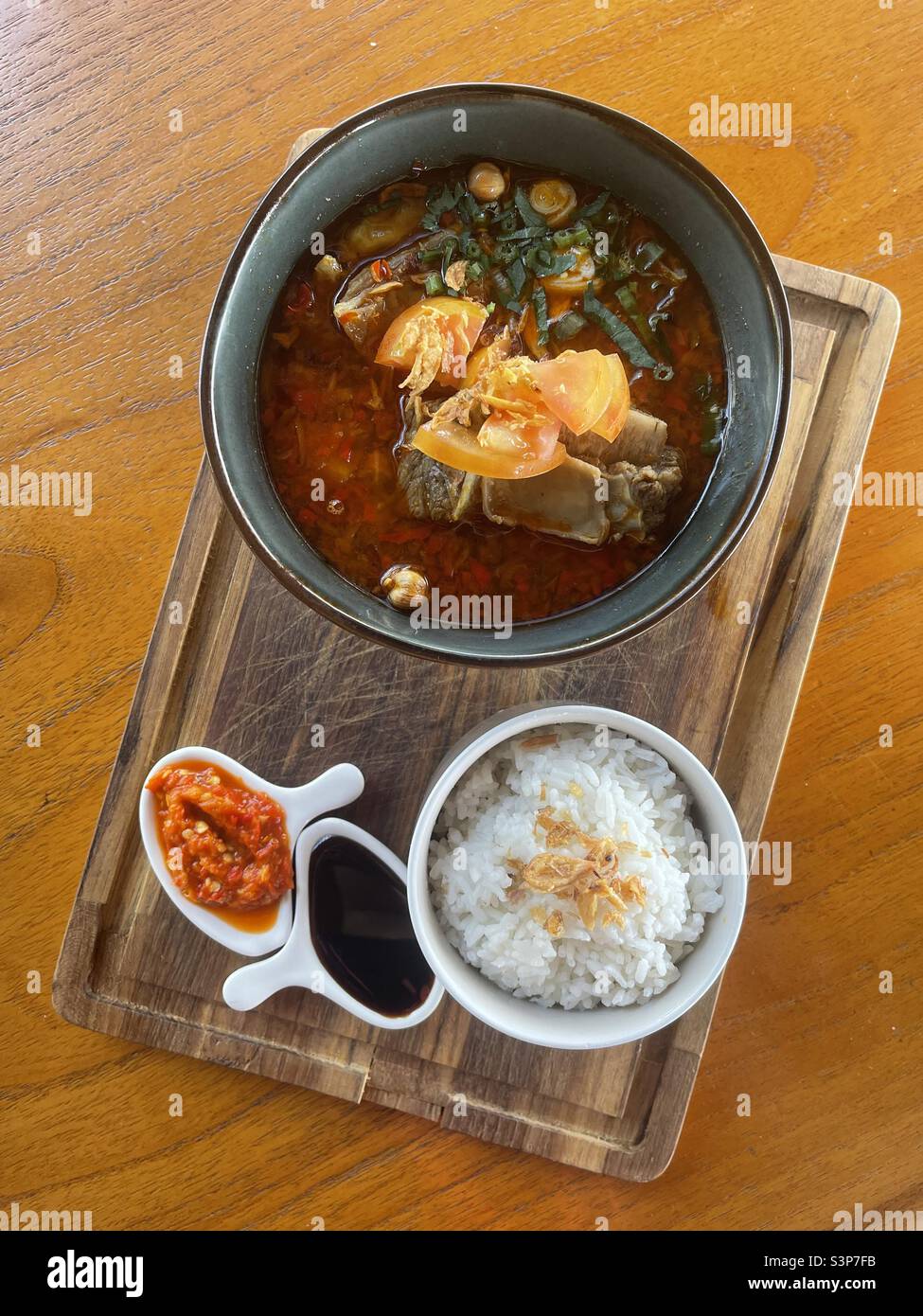 oxtail soup, rice and condiments Stock Photo