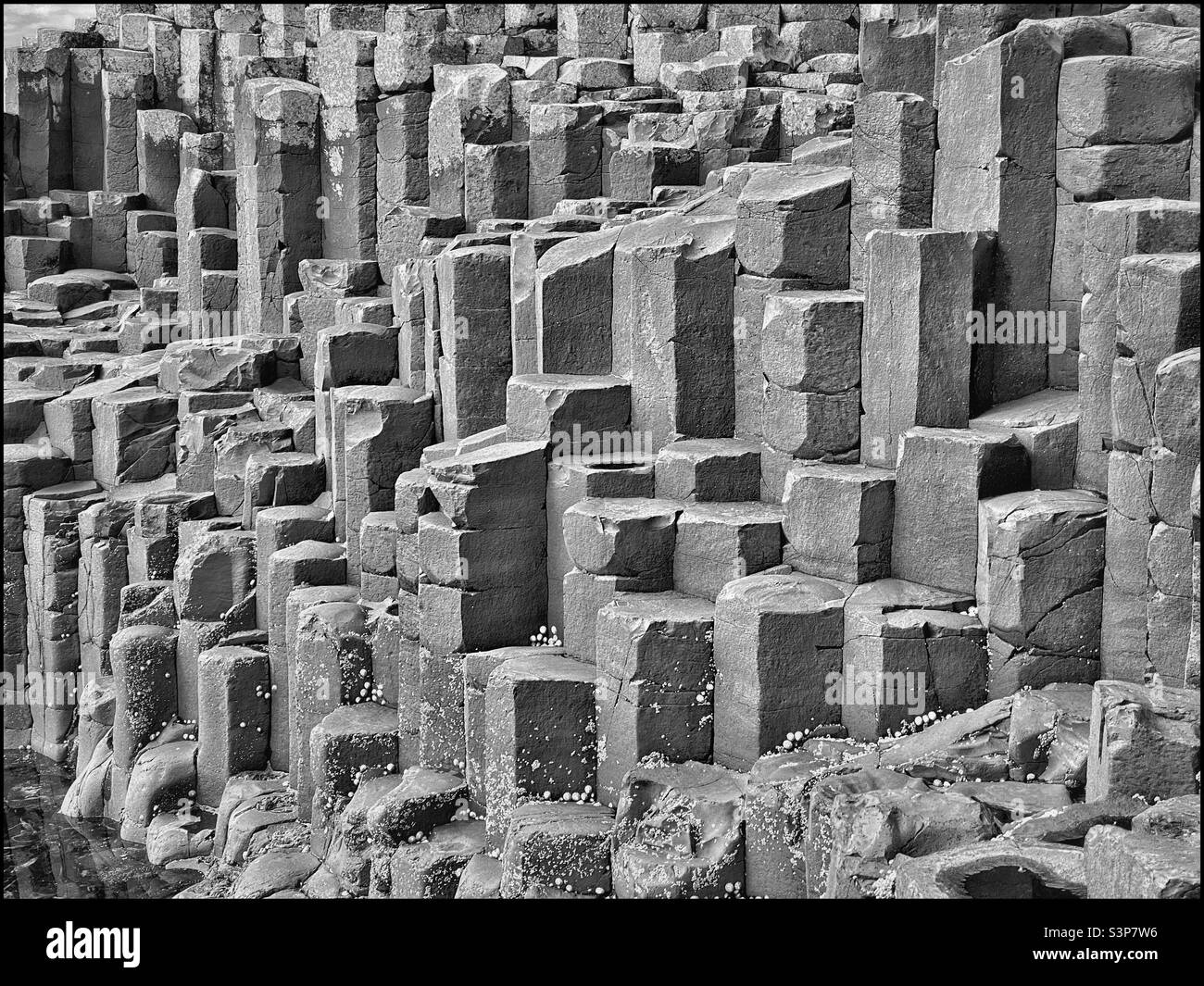 The hexagonal volcanic rock columns at Giant’s Causeway are unique and a major Northern Ireland tourist destination. This iconic location is a UNESCO World Heritage Site. Photo ©️ COLIN HOSKINS. - Smartphone Captured Stock Image