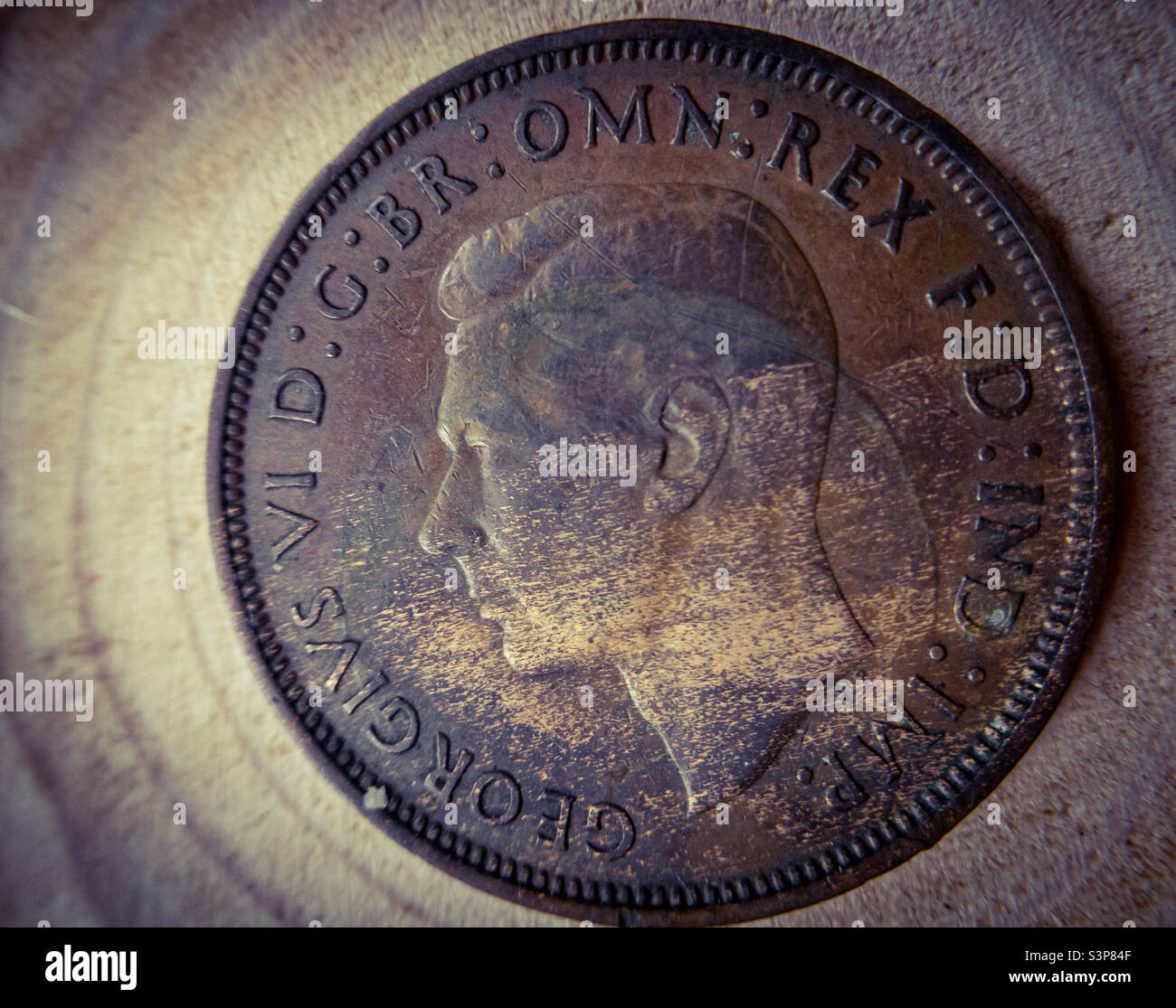 The head side of a 1938 English penny featuring George VI - Smartphone Captured Stock Image