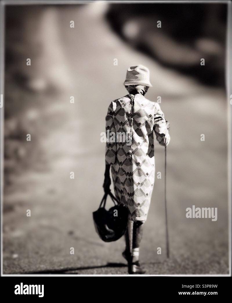 An elderly Jamaican woman walking down a country Road. - Smartphone Captured Stock Image