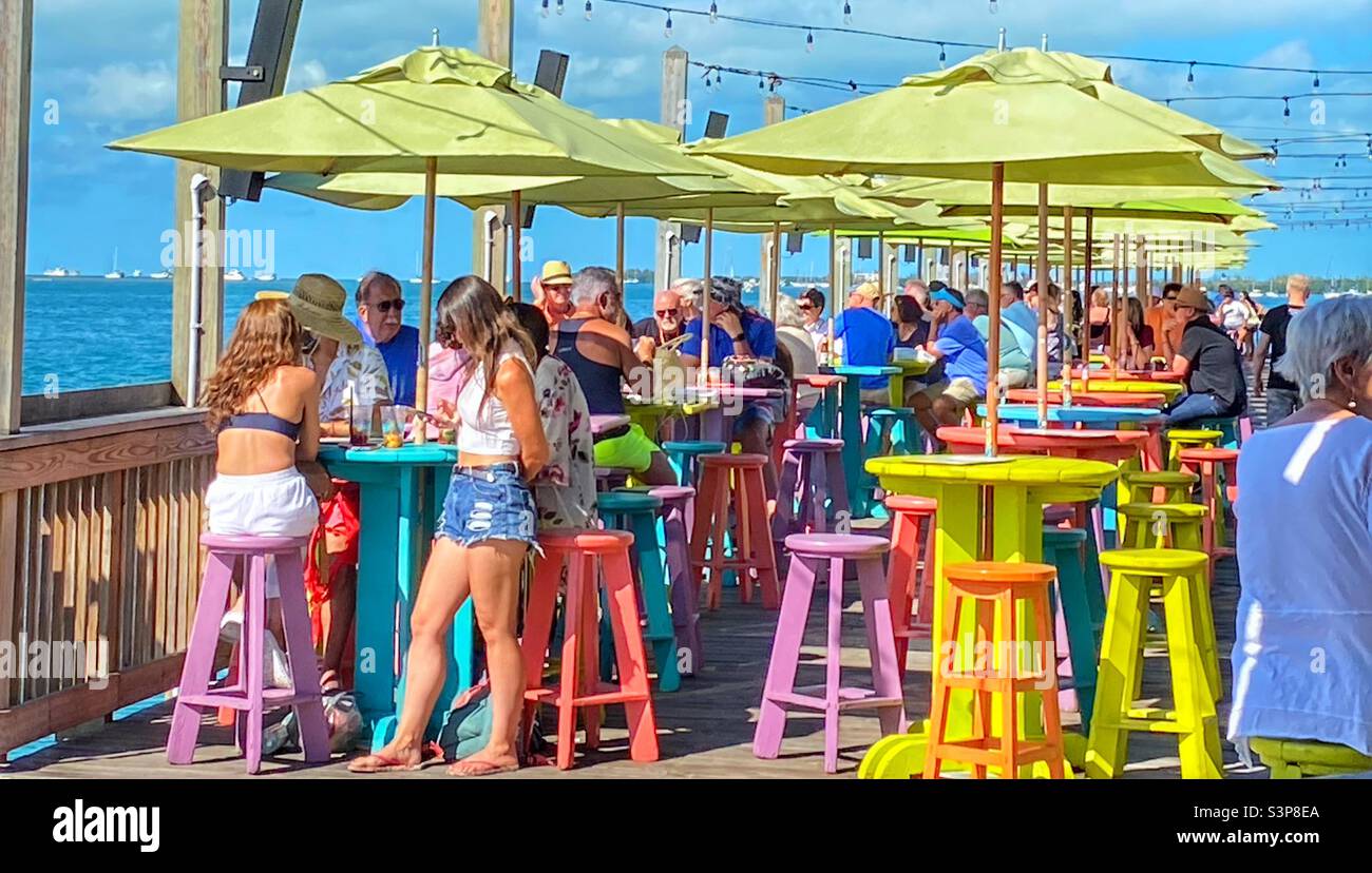 People eating outside at a pier side restaurant in Key West Florida Stock Photo