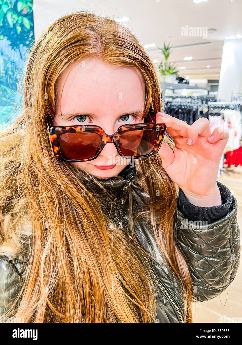 Young girl wearing sunglasses posing Stock Photo